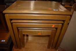 A modern light hard wood nest of three tables