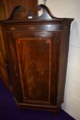 A 19th Century mahogany corner cabinet, having green painted shelves to the interior, with