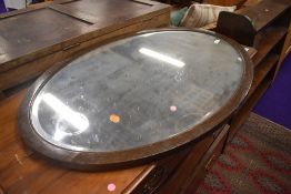An early 20th Century oak frame oval mirror, approx 95 x 65cm