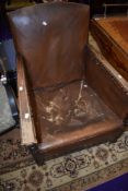 An early 20th Century oak framed armchair with leather or rexine upholstery (restoration project)