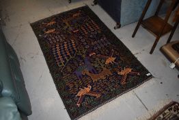 A Persian rug having vibrant animalistic style decoration, approx. 130 x 80cm