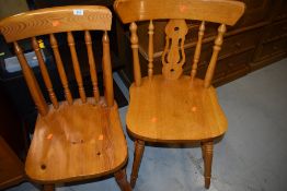 Two modern light stained kitchen chairs one pine and one beech wood