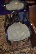A late Victorian dark stained frame armchair having upholstered seat and back