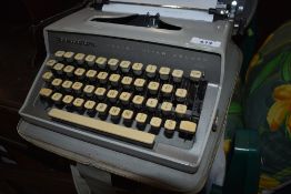 A vintage Typewriter, Remington Travel-Riter Deluxe , with integral case
