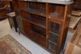 An early 20th Century mahogany bookcase, with narrow glazed display sections to each side, width