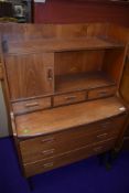 A vintage teak desk of small proportions, G plan or similar, having concealed stationery