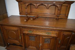 A Victorian golden oak sideboard, width approx. 213cm, having shorter ledge back