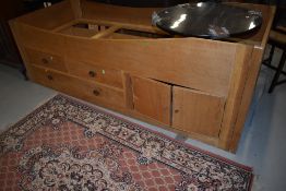 A single oak cabin bunk bed with two over one drawers and cupboard section. It is an exact cabin
