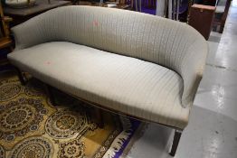 A 19th Century settee of wide proportions having shaped back , on eight mahogany tapered legs, width