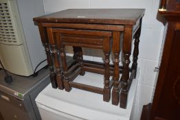A nest of priory style oak side tables