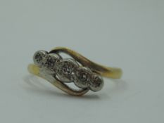 A lady's dress ring having 5 diamond chips in an illusionary setting to cross over shoulders on a