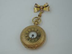 A lady's Victorian yellow metal half hunter top wound pocket watch stamped 18K of small form, having