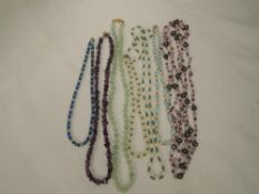 Seven strings of beads including polished amethyst style, crystal, jadeite style etc