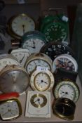 Fifteen vintage and retro alarm clocks, various colours, styles and eras.