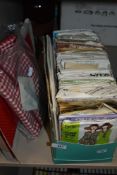 A box full of vintage and retro dress making patterns,boxed Irish linen two place table setting