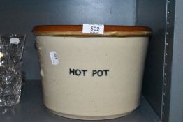 A large ceramic crock pot stamped hot pot