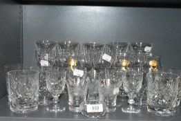 A selection of clear cut and crystal glass wares including Waterford wine glasses