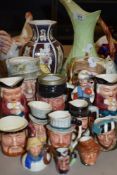 A large Carlton ware jug having fox gloves to green ground and a good quantity of character jugs