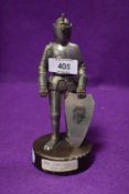 A Vintage table top cigarette lighter of a medieval knight with heavy weighted base