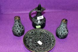 A ceramic sauce or cruet set with green glaze