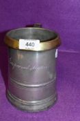 An antique pewter mug or Quart having impressed marks and brass rim