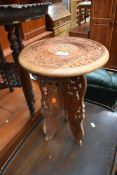 An Eastern carved occasional table