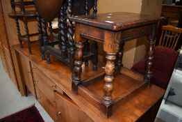 A traditional reproduction oak coffin stool style occasional table