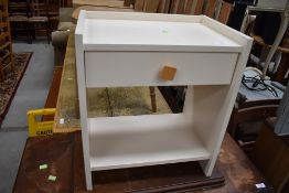 A painted laminate wood bedside cabinet