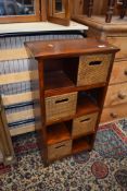 A small hardwood shelf with cane fronted style drawers