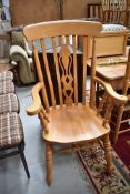 A traditional beech or rubberwood carver chair