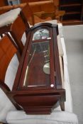 A reporduction mahogany effect wall clock