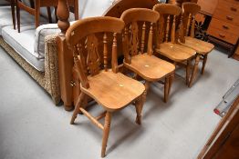 A set of four solid seat golden oak traditional style kitchen chairs, stamped 1998