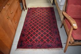 A traditional Afghan style rug, red ground, approx. 147 x 88cm