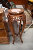 An Oriental plant stand with oriental insert , height approx. 90cm