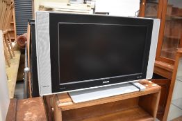 A Phillips HD flat screen television set with remote 26 inch, and a DVD player