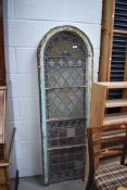 An arch stairway or similar window frame, being glazed with vintage coloured and leaded glass and