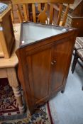 An interesting oak triangular corner cupboard having illusionary bijouterie top, possibly having