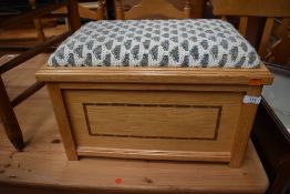 A modern golden oak box stool having knitted seat