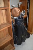 A selection of golf clubs including King Cobra and Daiwa, with bag and balls