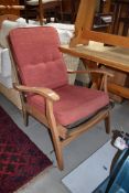 A vintage stripped frame armchair , later upholstery