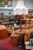 An early 20th Century mahogany standard lamp with integral side table, twist column and triple splay