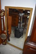 a gilt framed hall way mirror