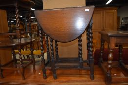 An early to mid 20th Century oak twist leg occasional table