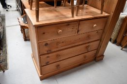 A natural pine chest of two over three drawers