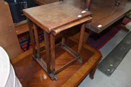 A vintage oak part nest of two tables
