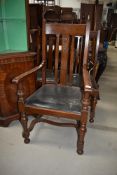 A set of five (four plus one) oak dining chairs having rail backs, turned frame and H stretcher
