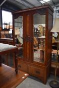 A Victorian mahogany mirror door wardrobe having single drawer base