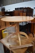 A modern beech effect having rocket style quadruple legged base, diameter approx 91cm