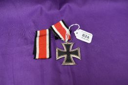 A German 1939 Iron Cross with ribbon and a spare ribbon