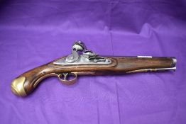 A 19th century flintlock pistol, brass mounts, ram rod, lock plate stamped Tower, Crown with GR